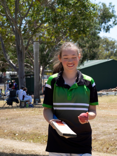 Girl's team female cricket player getting ready to play smiling - Australian Stock Image