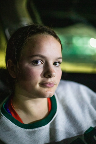 Girl sitting inside the car at night - Australian Stock Image