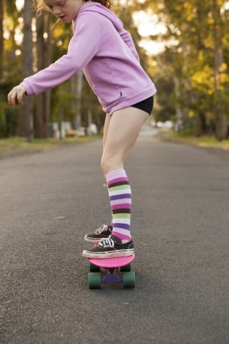Girl skateboarding in a street - Australian Stock Image
