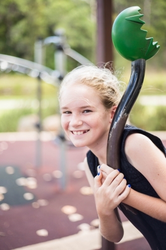 Girl spinning on equipment at park - Australian Stock Image