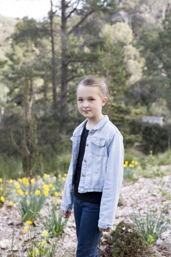 Girl standing in front of bushland - Australian Stock Image