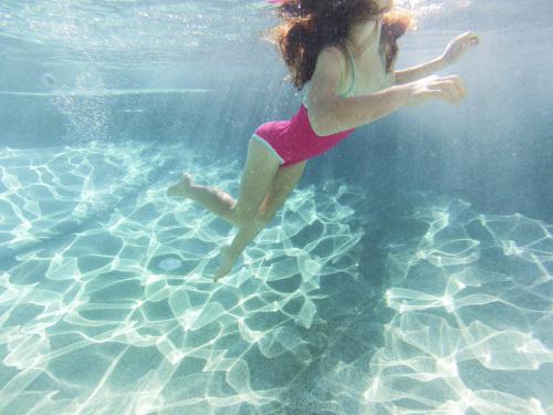 Girl swimming underwater in a pool