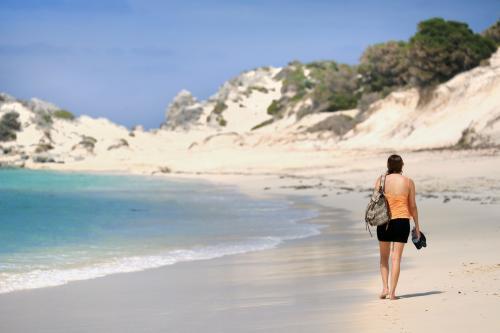 Girl walking along the beach - Australian Stock Image