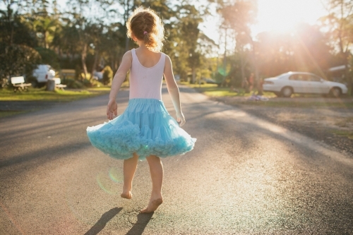 Girl walking down a street in a tutu skirt - Australian Stock Image