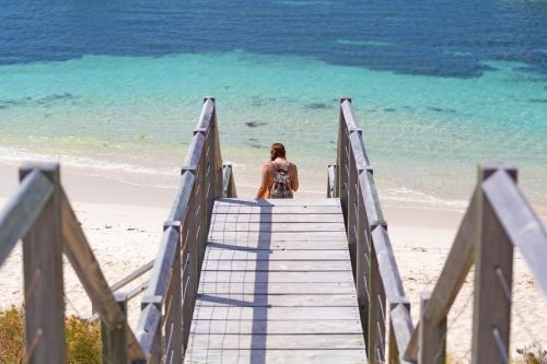 Girl walking down steps to the beach - Australian Stock Image