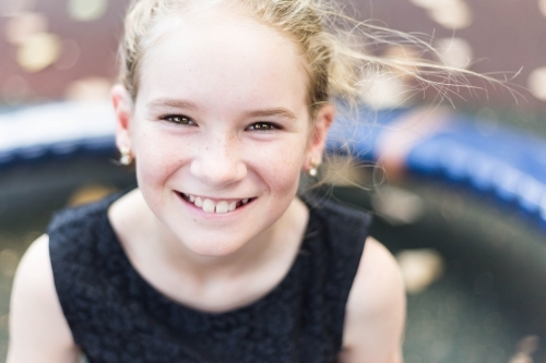 Girl with missing tooth smiling - Australian Stock Image