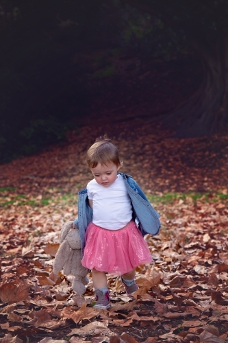 Girl With Toy Rabbit Running and Playing in Autumn Leaves