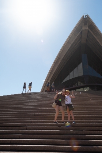 girls posing in front of Sydney Opera House - Australian Stock Image
