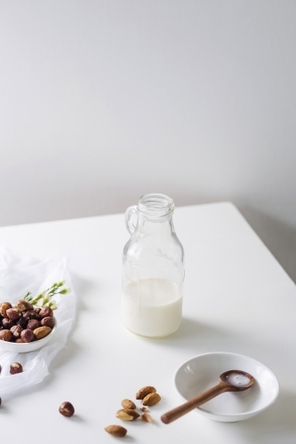 Glass bottle filled with nut milk - Australian Stock Image