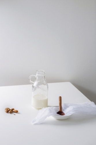 Glass bottle filled with nut milk - Australian Stock Image