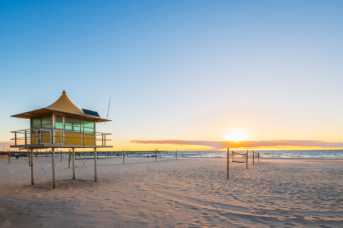 Glenelg Beach Surf life saving tower at sunset - Australian Stock Image