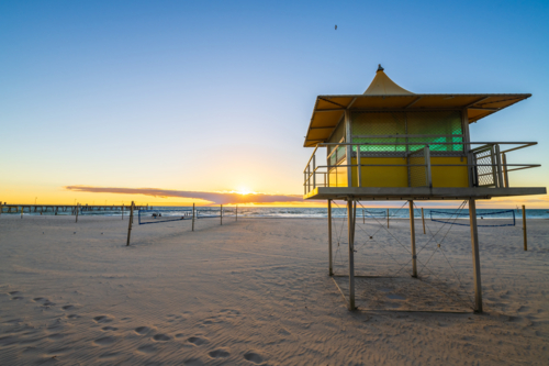 Glenelg Beach Surf life saving tower at sunset, South Australia - Australian Stock Image