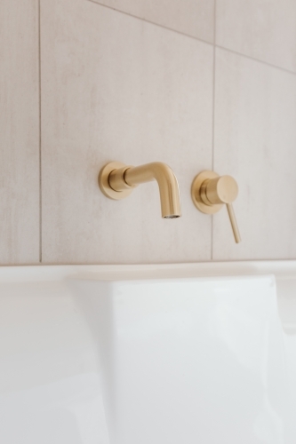 Golden bath tap and handle - Australian Stock Image