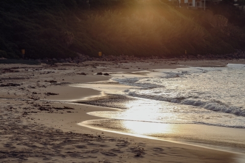 Golden sunlight on the beach in late afternoon - Australian Stock Image