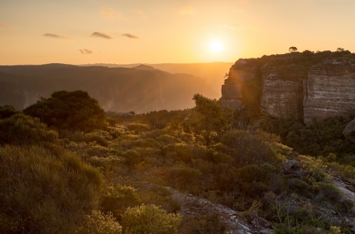 Golden sunset across the rugged escarpment cliffs