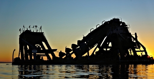 Golden sunset over sunken shipwrecks
