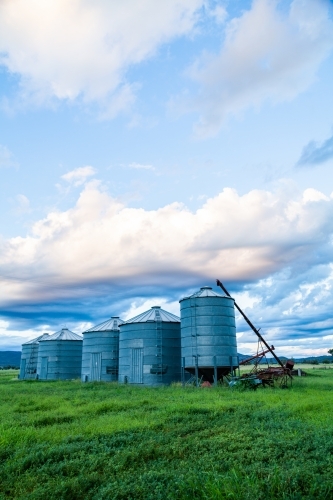 Good times on a farm with green grass and grain silos - Australian Stock Image