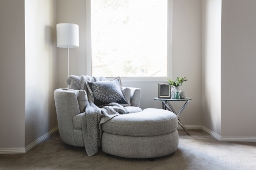 Gorgeous bedroom sofa chair with throw rug and cushion - Australian Stock Image