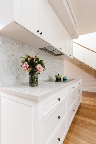 Gorgeous kitchen cabinetry detail with stunning marble herringbone back splash - Australian Stock Image