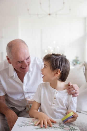 Grandad with grandson opening Christmas present - Australian Stock Image