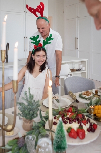 Grandfather and granddaughter at Christmas dining table - Australian Stock Image