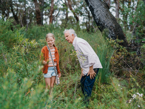 Grandfather exploring Australian Bushland with granddaughter - Australian Stock Image
