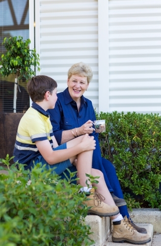 Grandma having cup of tea with grandson - Australian Stock Image