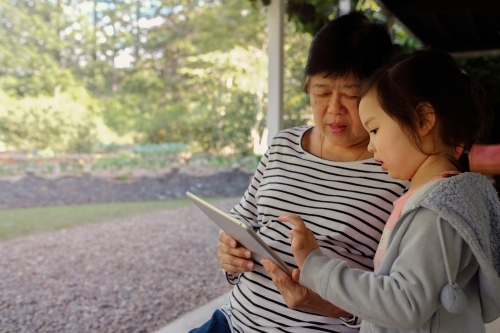 Grandmother and granddaughter using tablet