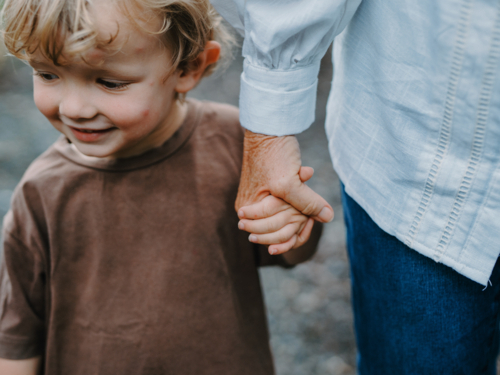 Grandmother holding grandsons hand - Australian Stock Image