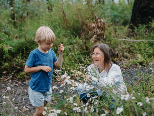 Grandmother spending time with grandson in nature - Australian Stock Image