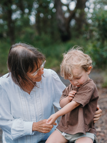 Grandmother spending time with grandson in nature - Australian Stock Image
