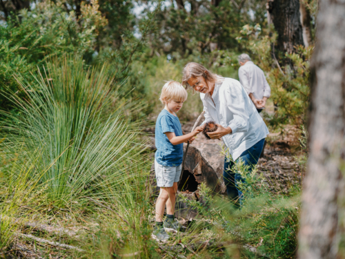 Grandmother spending time with grandson in nature exploring the bush - Australian Stock Image