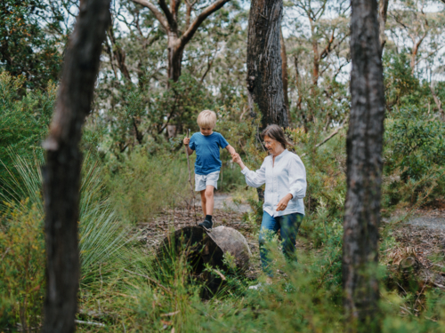 Grandmother spending time with grandson in nature exploring the bush - Australian Stock Image