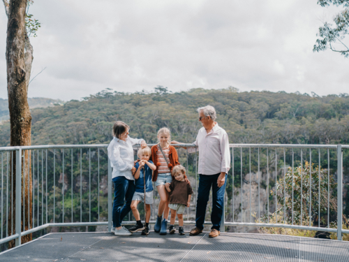 Grandparents enjoying Australian Bushland with their Grandchildren standing at lookout - Australian Stock Image