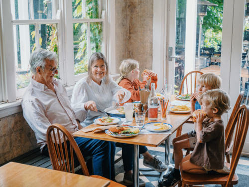 Grandparents enjoying lunch with their young grandchildren - Australian Stock Image