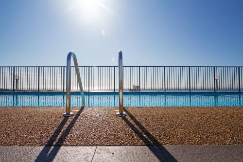 Graphic lines and patterns in swimming pool with sun flare