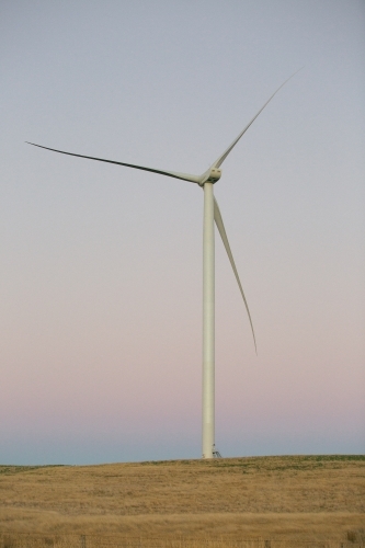 Green energy wind turbine in the countryside at dusk