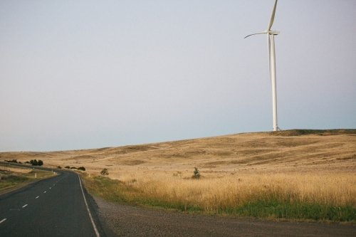 Green energy wind turbine in the countryside at dusk - Australian Stock Image