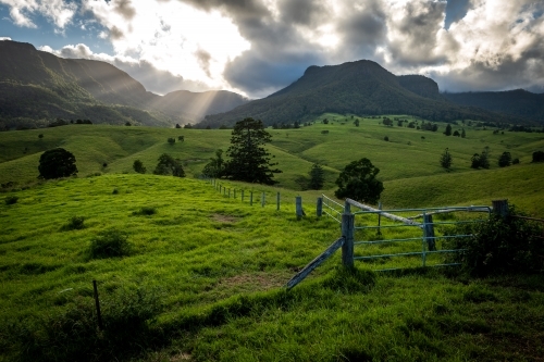 Green farming valley surrounded by Mountains - Australian Stock Image