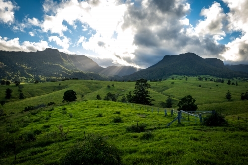 Green farming valley surrounded by Mountains - Australian Stock Image
