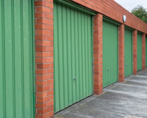 Green garage doors and red bricks