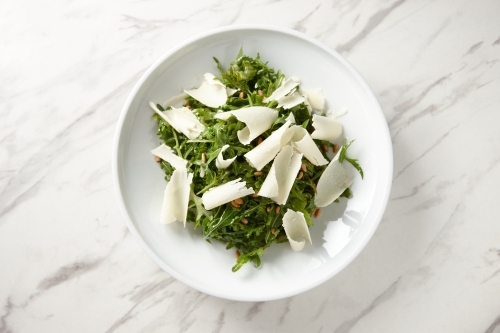 green salad mixed with nuts and largely grated cheese - Australian Stock Image