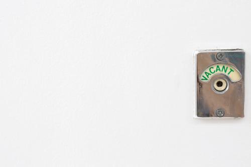 Green vacant sign turned on in public toilet. - Australian Stock Image