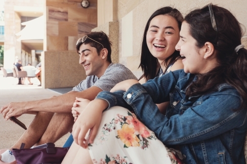 Group of happy international students in university library - Australian Stock Image
