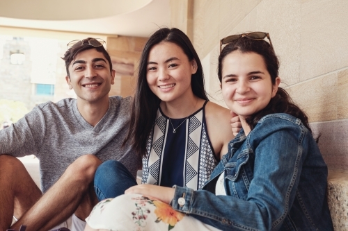 Group of happy international students in university library - Australian Stock Image