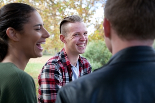 Group of young people laughing outdoors - Australian Stock Image