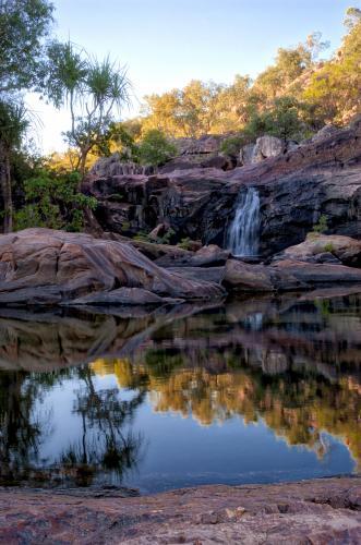 Gunlom watering hole with falls and reflection - Australian Stock Image
