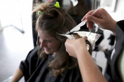 Hairdresser adding foils to a woman's hair - Australian Stock Image