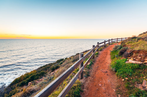 Hallett Cove Conservation Park Coastal Walkway along the coast with sea views at sunset - Australian Stock Image