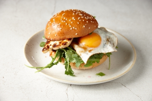 Haloumi and egg burger on plate - Australian Stock Image